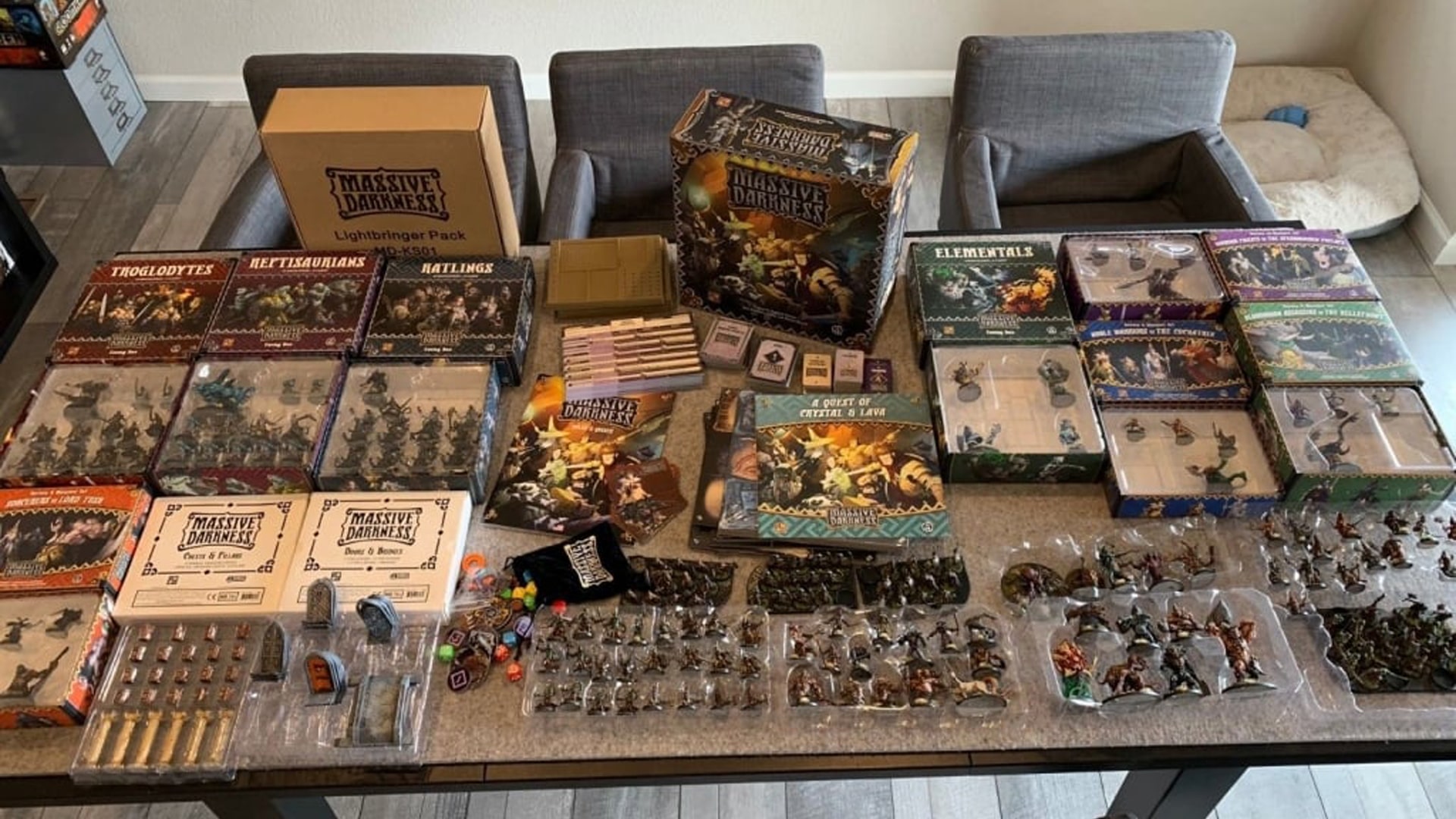 A detailed view of 'Massive Darkness' board game setup, featuring intricate miniatures and a dark, fantasy-themed game board.