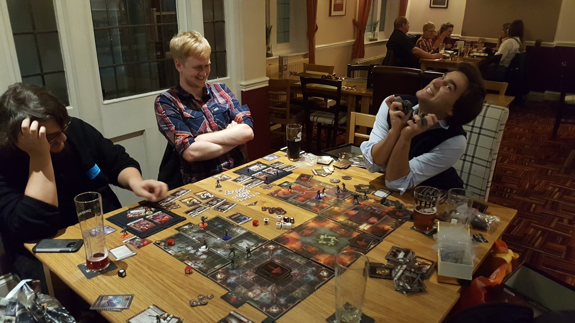 A lively scene from a tabletop gaming club, showing enthusiasts engaged in various board games, reflecting the social and community aspect of tabletop gaming.