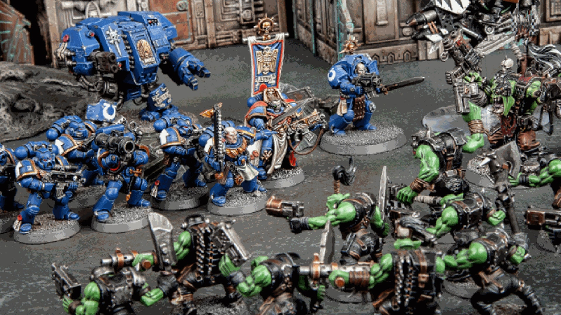 Detailed miniature models from Warhammer 40k, a popular tabletop game, showcasing intricate design and vibrant colors.