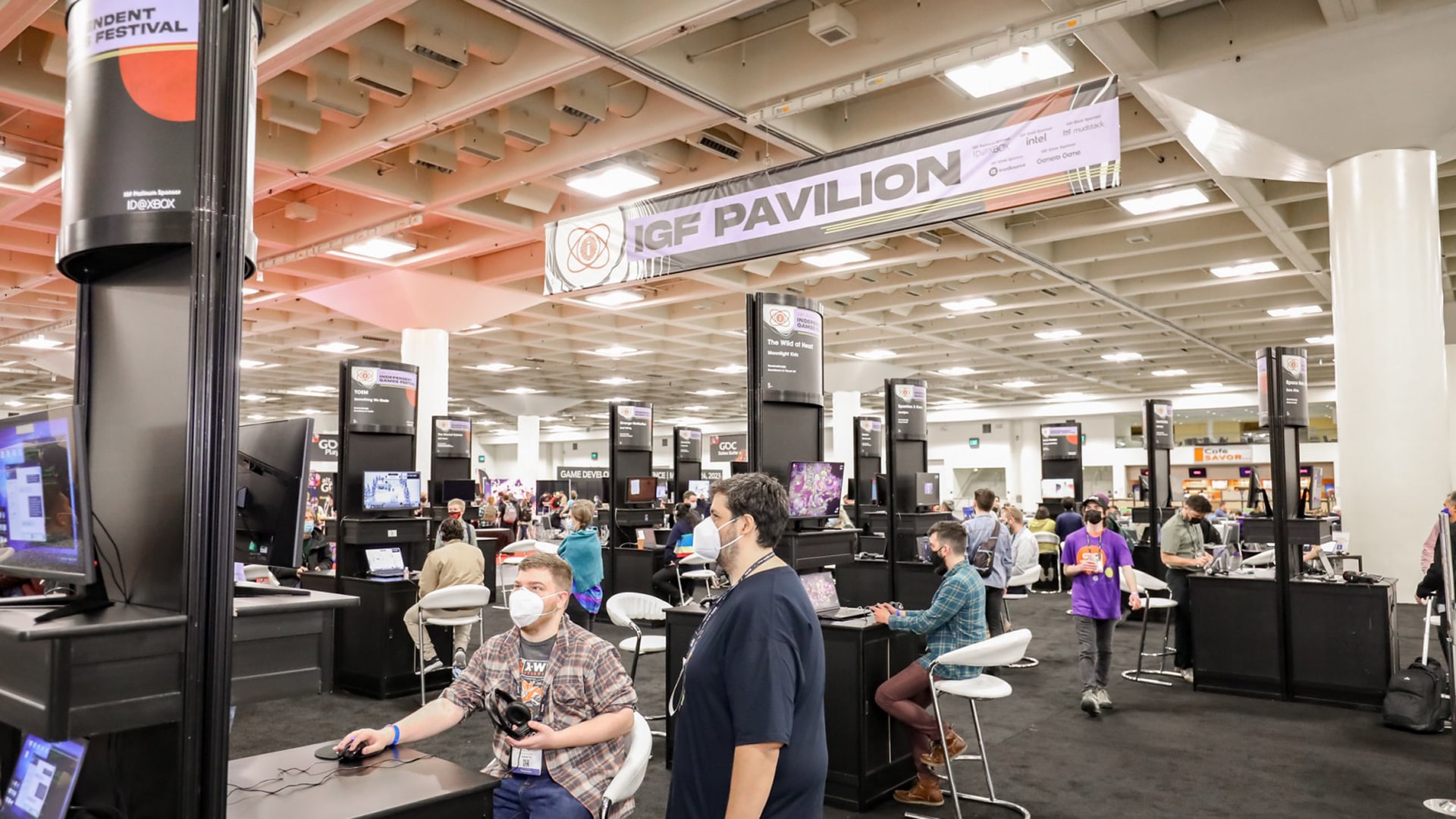 Indie Developers Collaborating at GDC 2023 Group of game developers discussing game development at GDC 2023